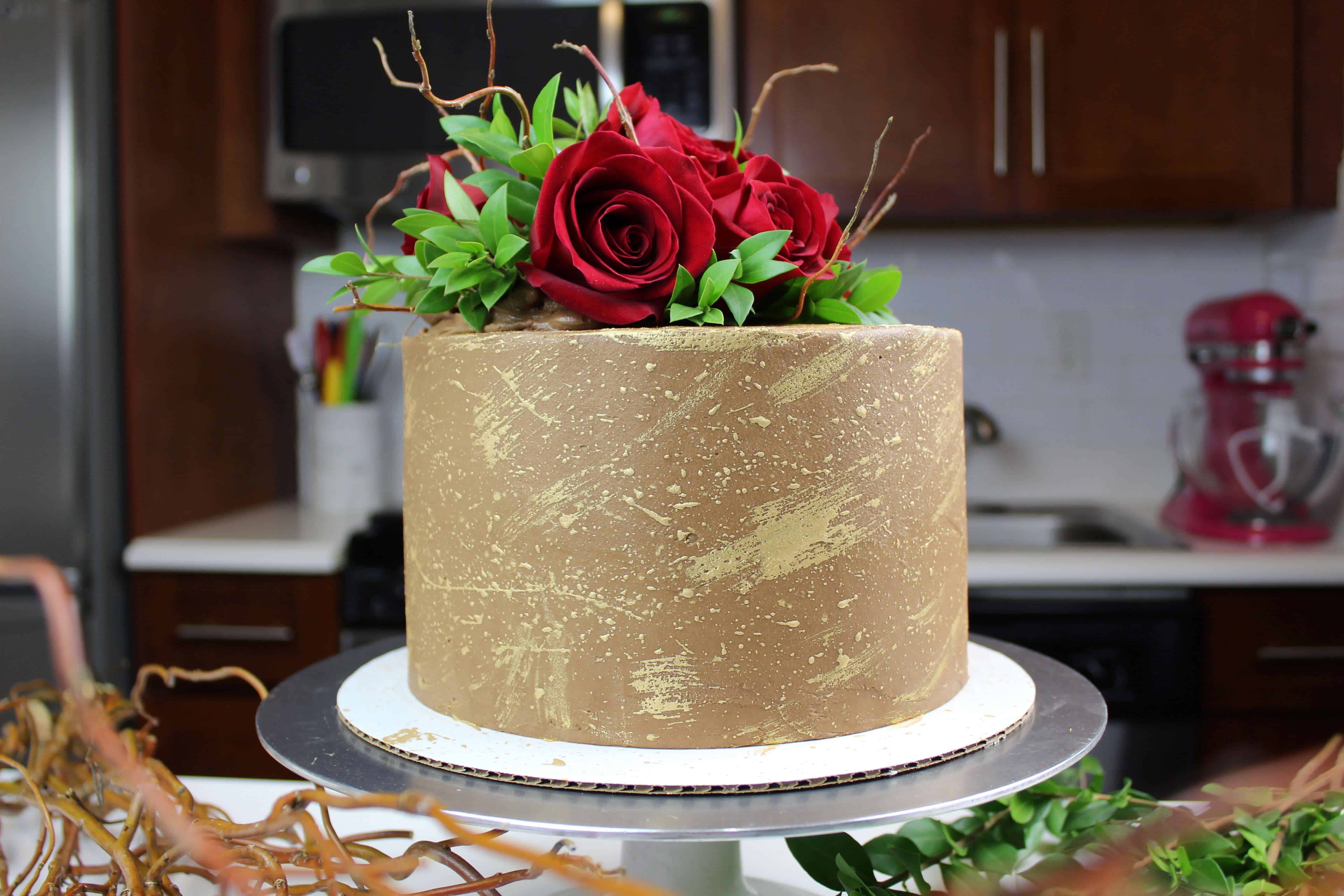 巧克力订婚蛋糕装饰可食用的黄金和新鲜的玫瑰照片