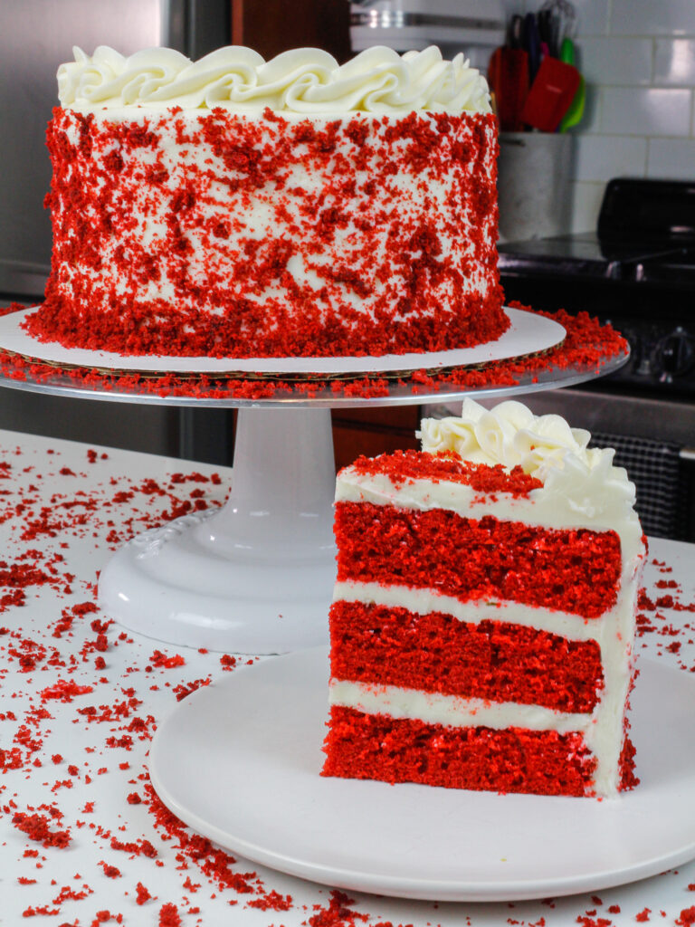 image of sliced red velvet cake, decorated with cake crumbs