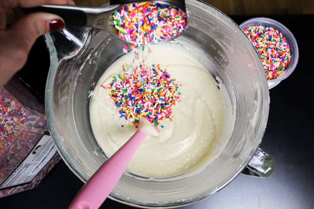 加入合适的类型彩虹的图像洒入funfetti蛋糕面糊