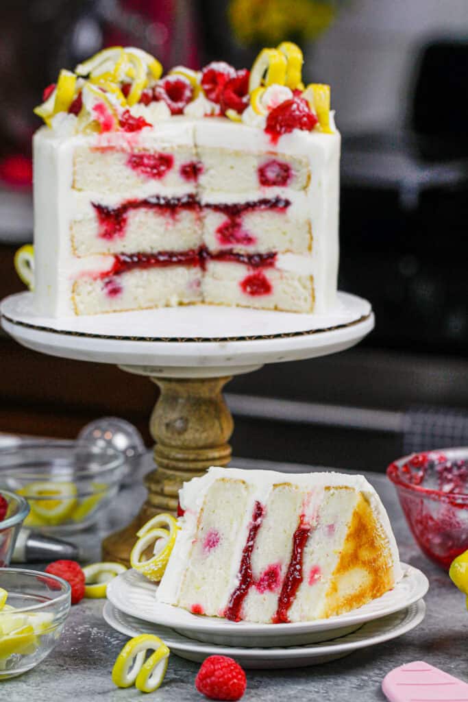 image of lemon raspberry cake slices open to show lemon cream cheese frosting and raspberry filling
