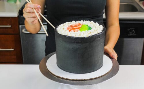 image of a sushi roll cake made with fluffy vanilla cake layers