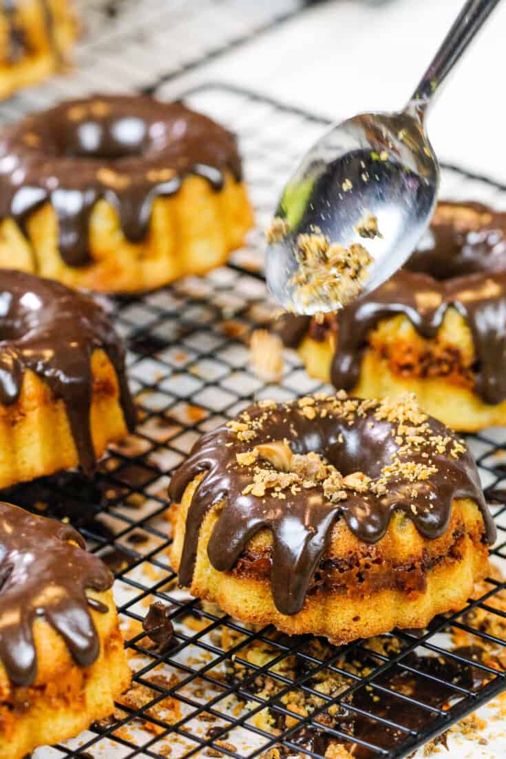 image of butterfinger bits being added to mini butterfinger bundt cakes