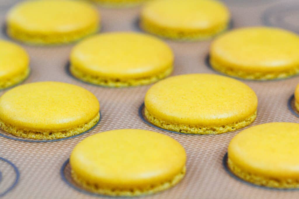 完美烤黄色macaron壳的图象与脚和没有褐色