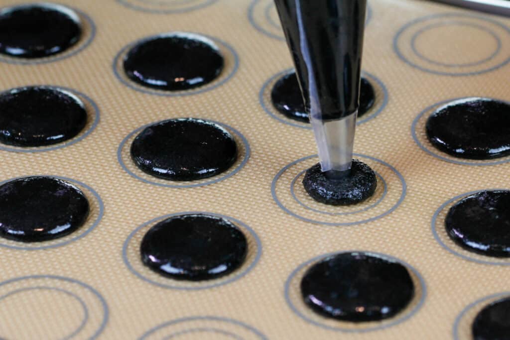 黑巧克力马卡的图像被用管道输送到silpat垫