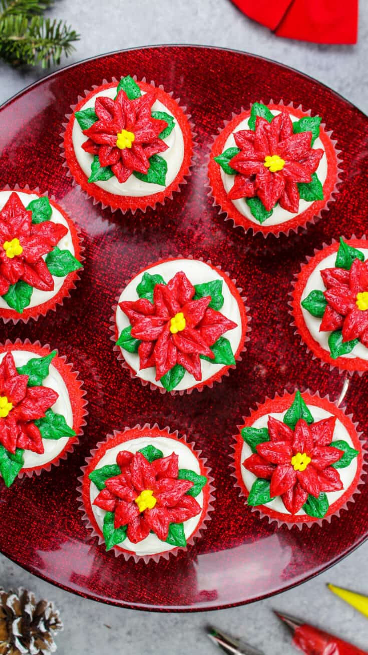 image of poinsettia cupcakes placed on a festive red cake stand