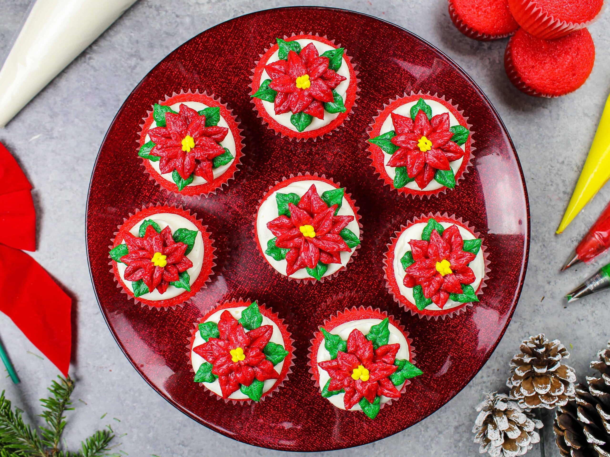 image of poinsettia cupcakes placed on a festive red cake stand