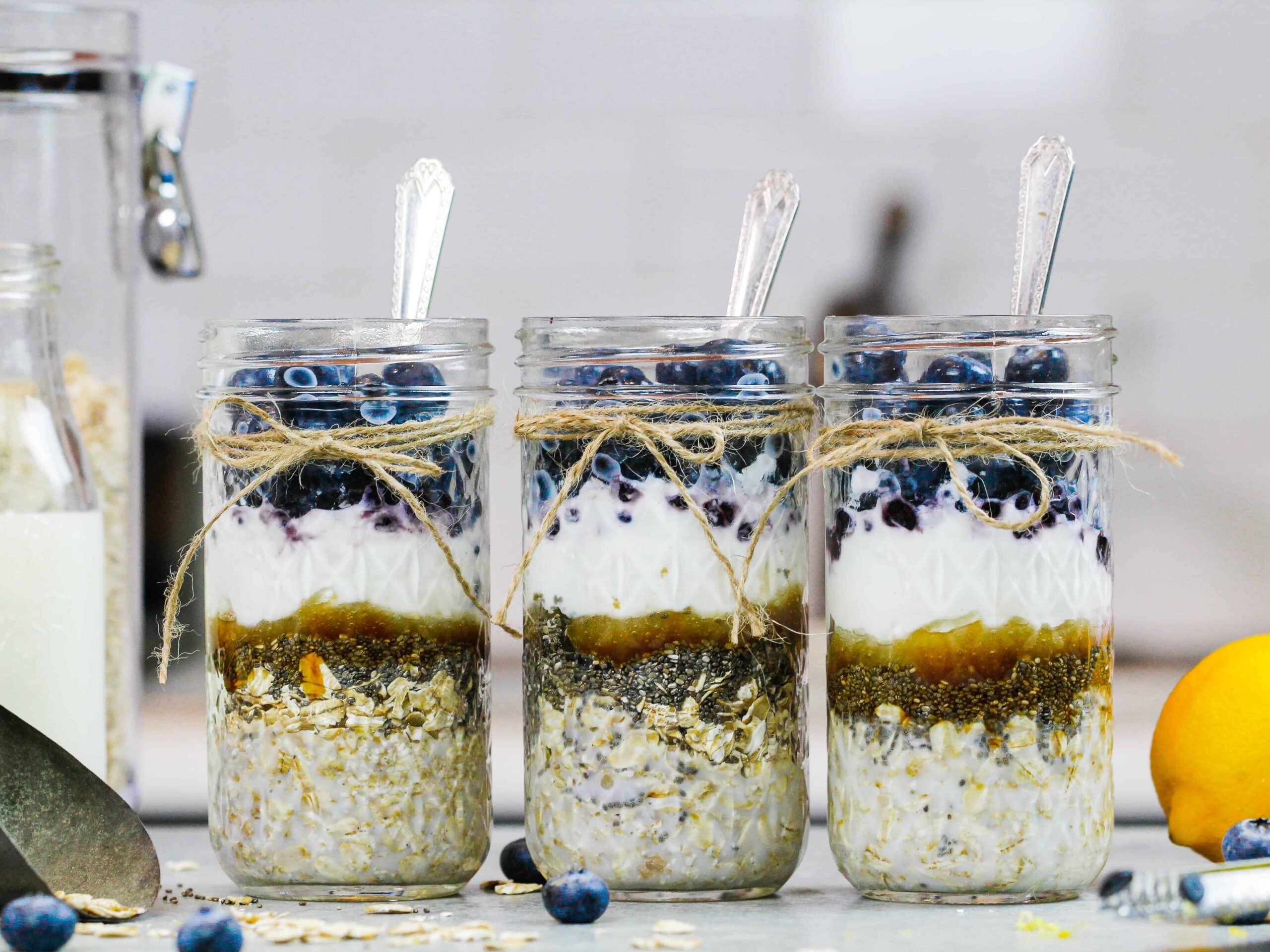 image of blueberry overnight oats filled in mason jars before being stirred with milk
