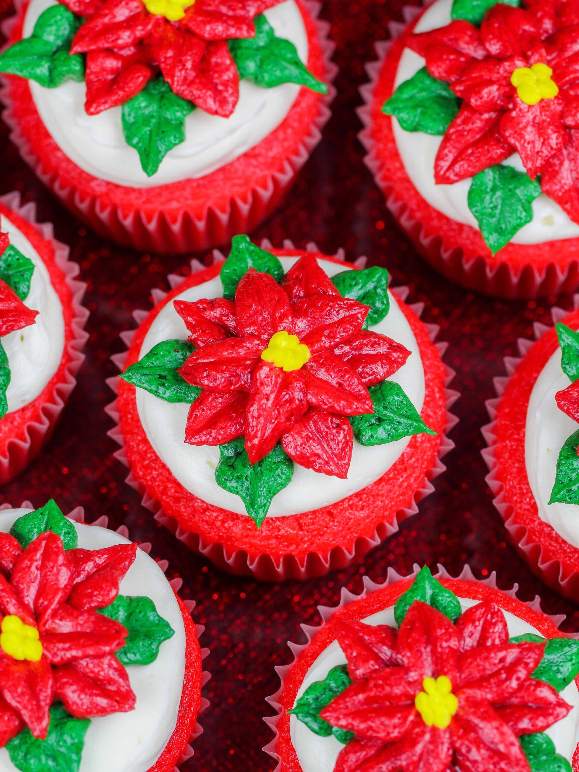 image of poinsettia cupcakes placed on a festive red cake stand
